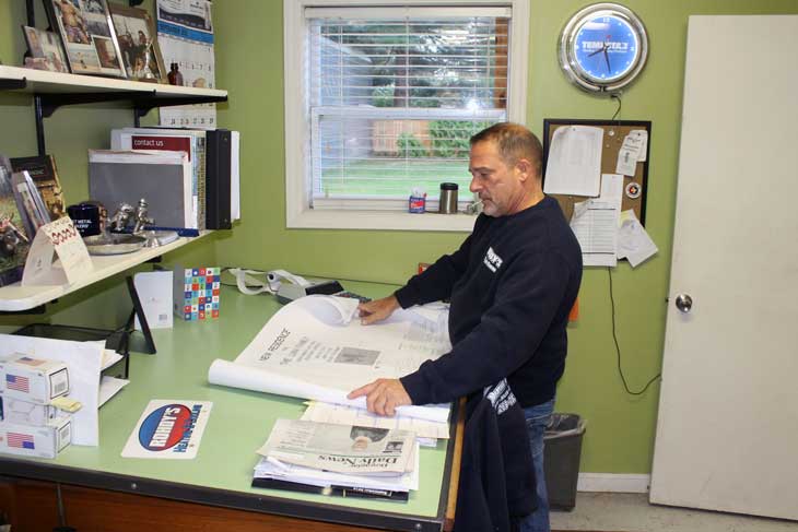 Photo of owner Chris Rohdy reviewing intallation plans.